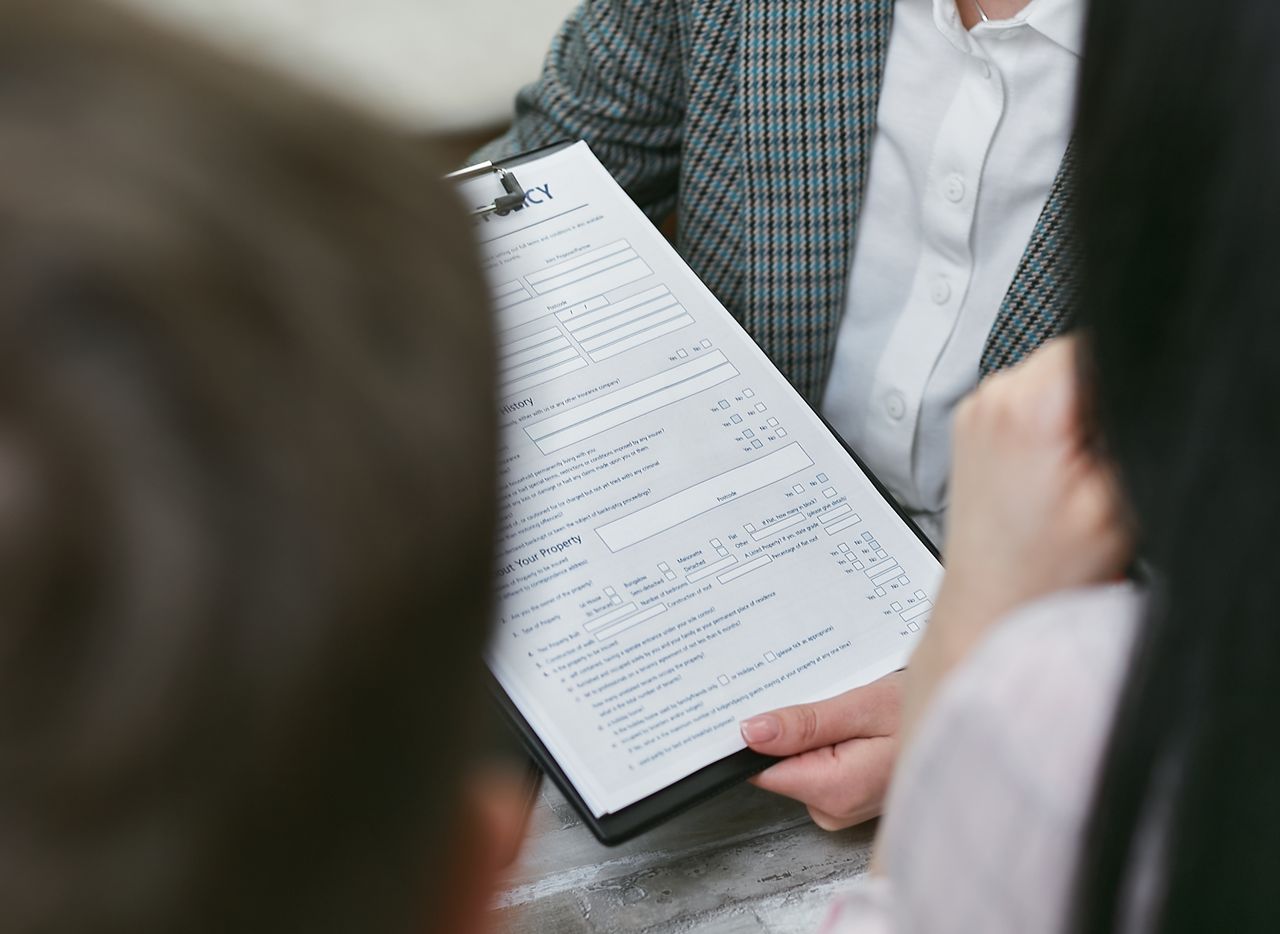 Home Close-up of professionals discussing a legal contract during a business meeting.